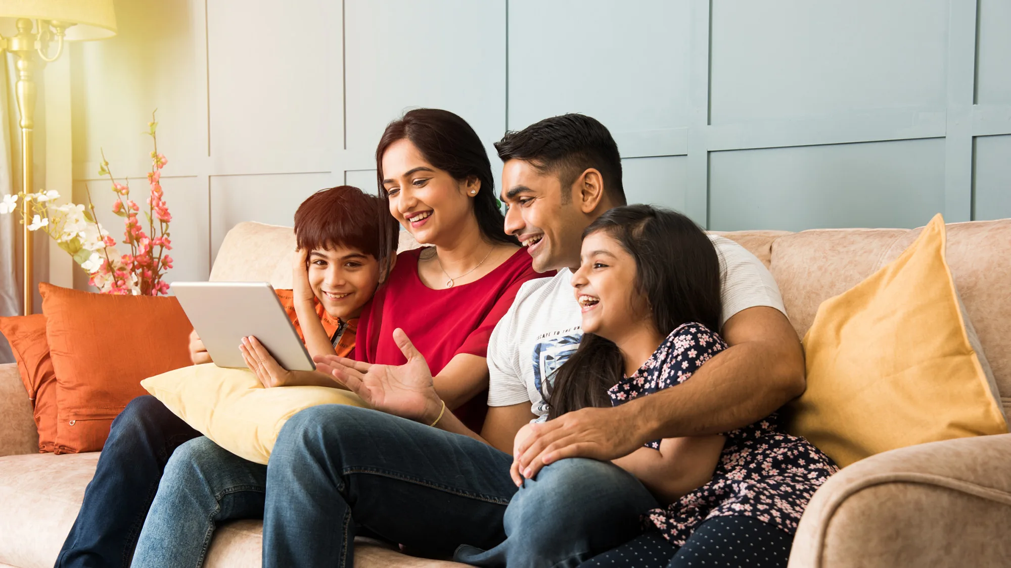Indian family sharing a happy moment together in their living room