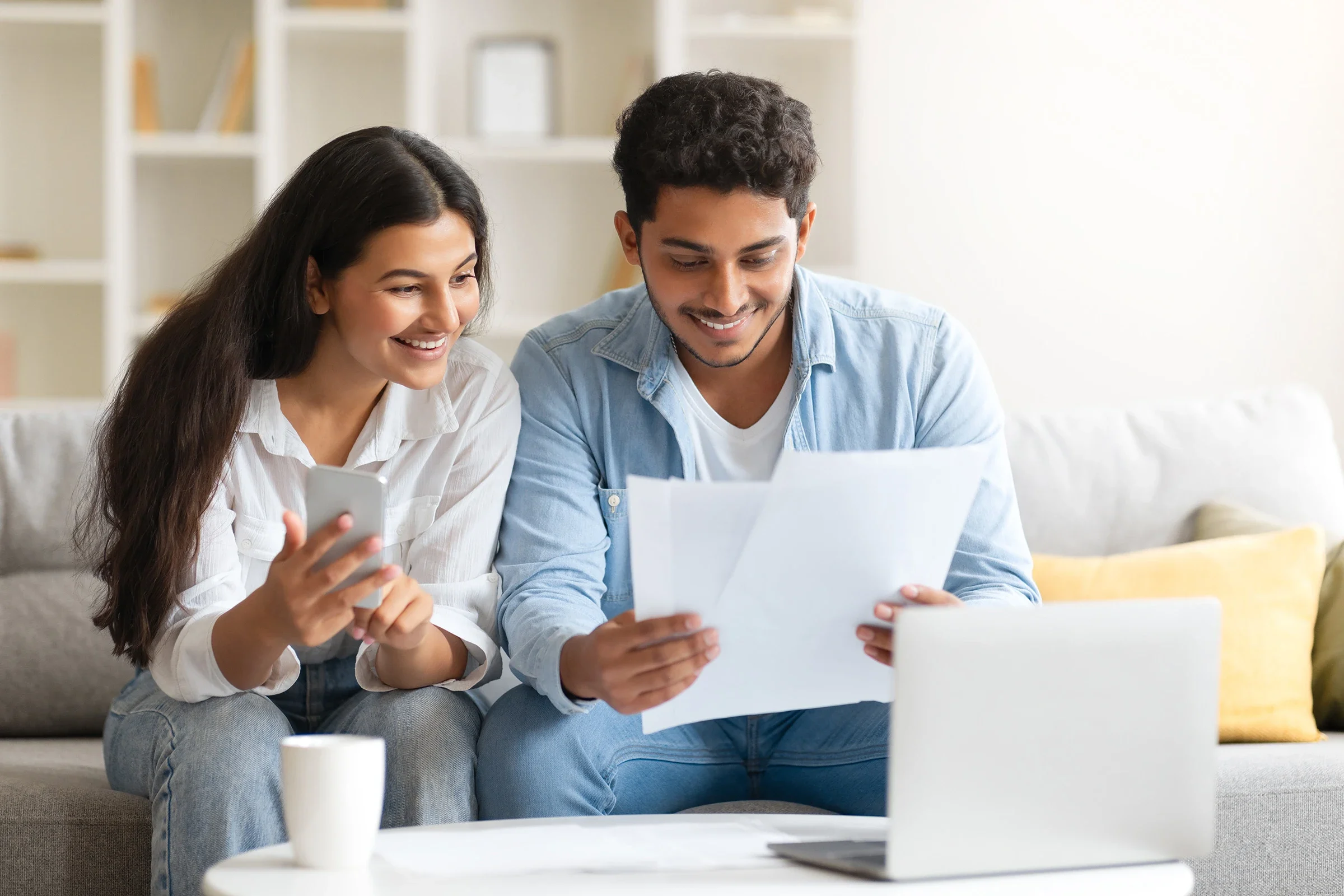 Indian couple reviewing paperwork together at home